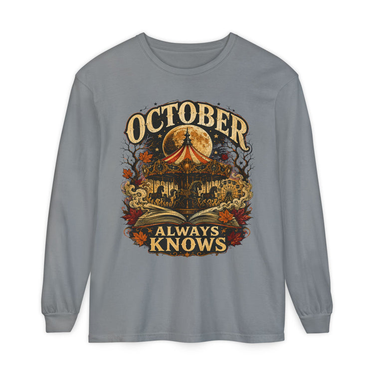 A gray long-sleeve t-shirt with a vintage-style Halloween graphic on the front. The graphic features a haunted house, a glowing full moon, a red-and-yellow circus tent, autumn leaves, and the text &