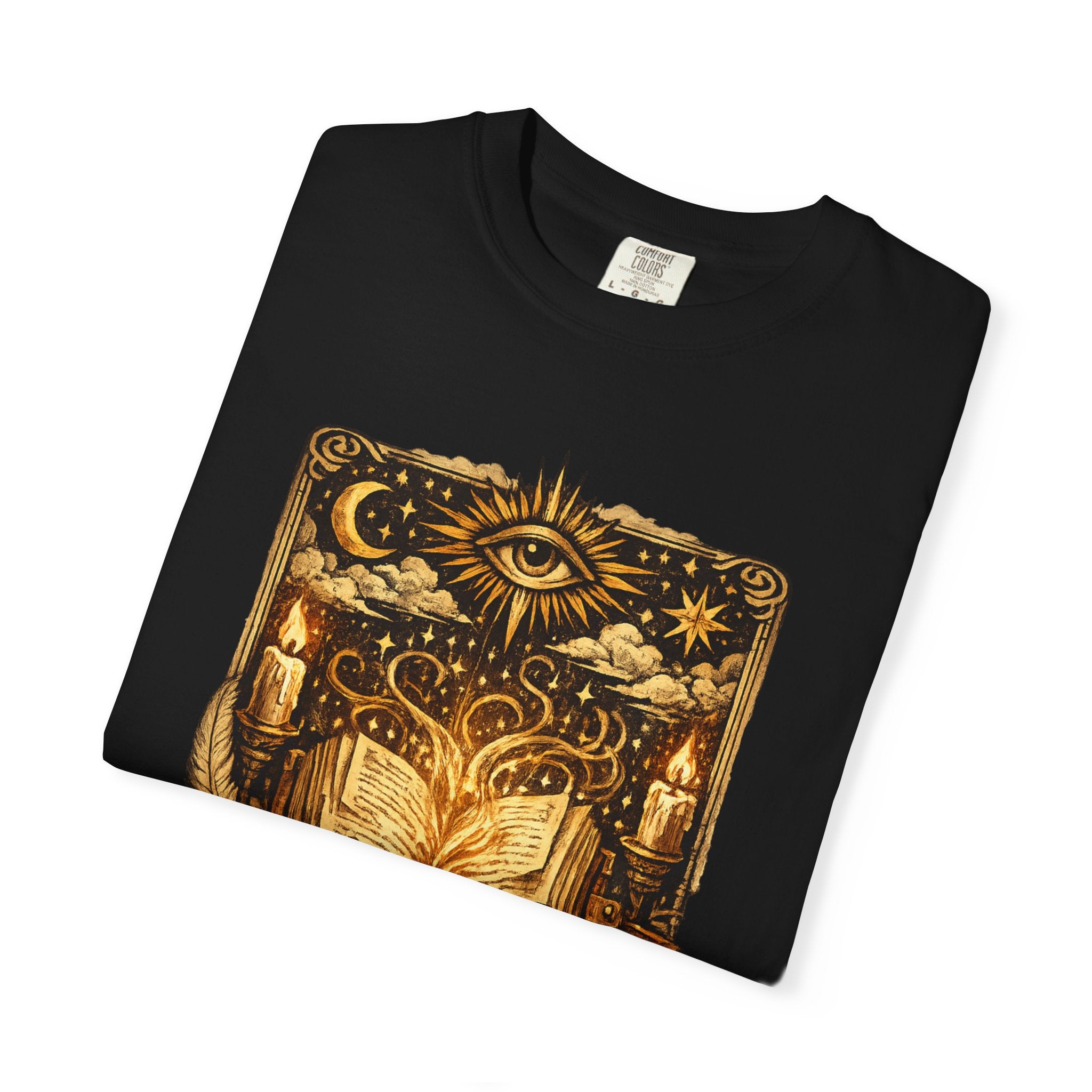 Black t-shirt with gold mystical design featuring an eye, candles, and books on a white background
