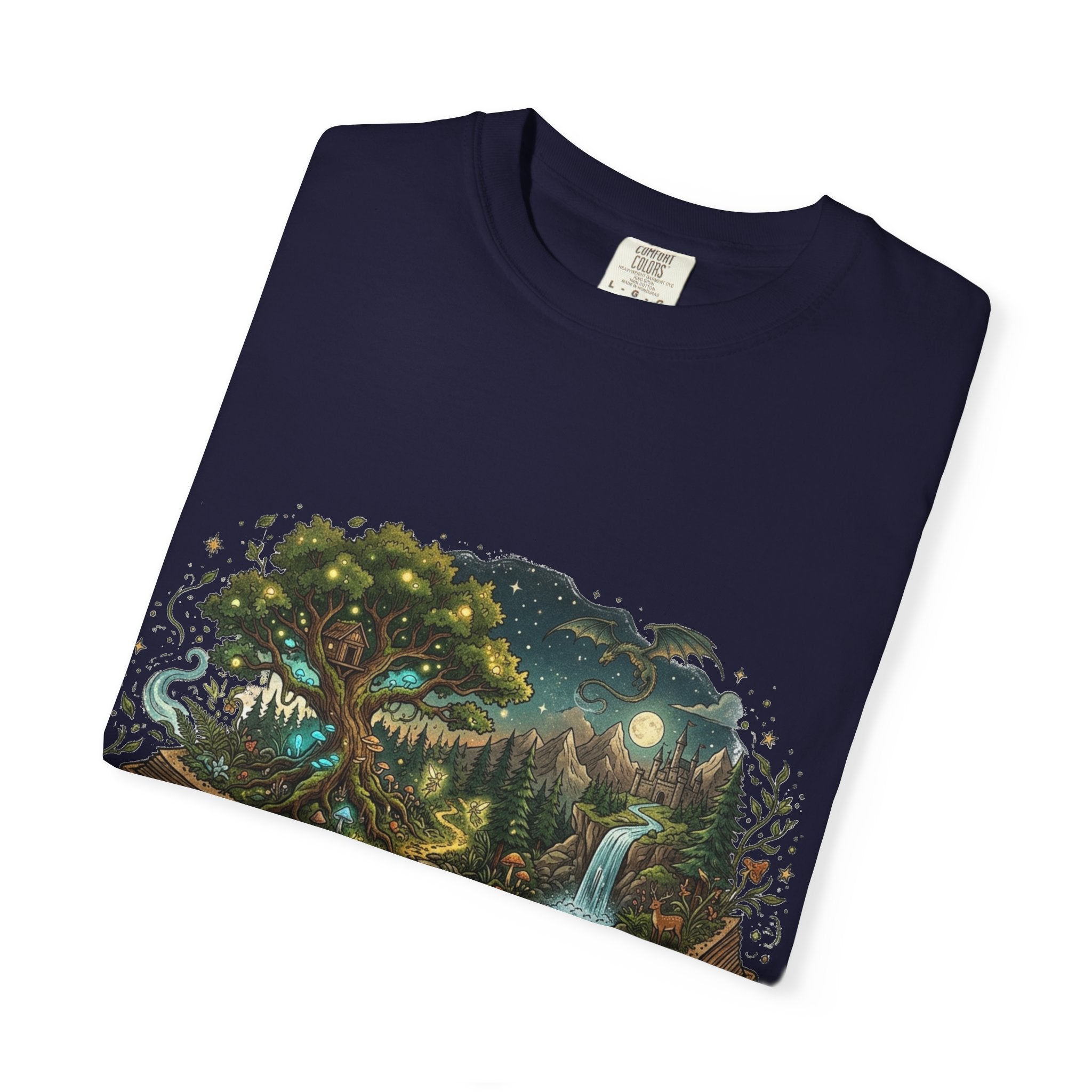 Fantasy book lover tee featuring an enchanted forest, waterfall, and castle emerging from an open book.