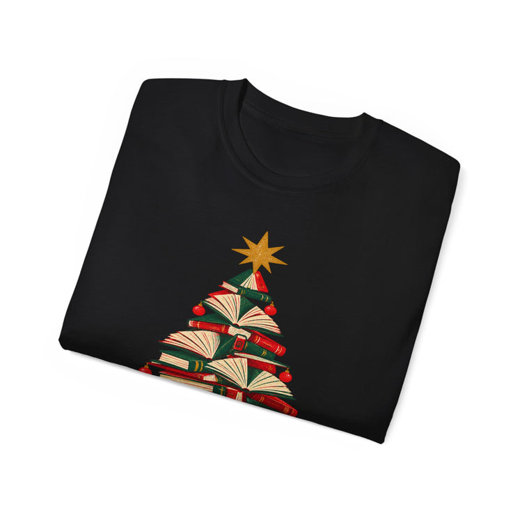 A folded black crewneck t-shirt featuring a Christmas tree graphic made of stacked books with a gold star on top, displayed on a clean white background.