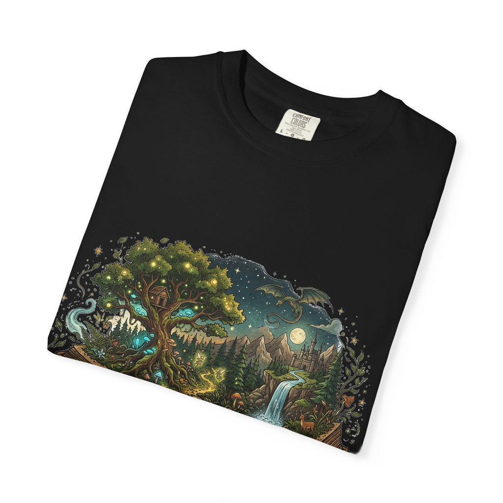 Fantasy book lover tee featuring an enchanted forest, waterfall, and castle emerging from an open book.
