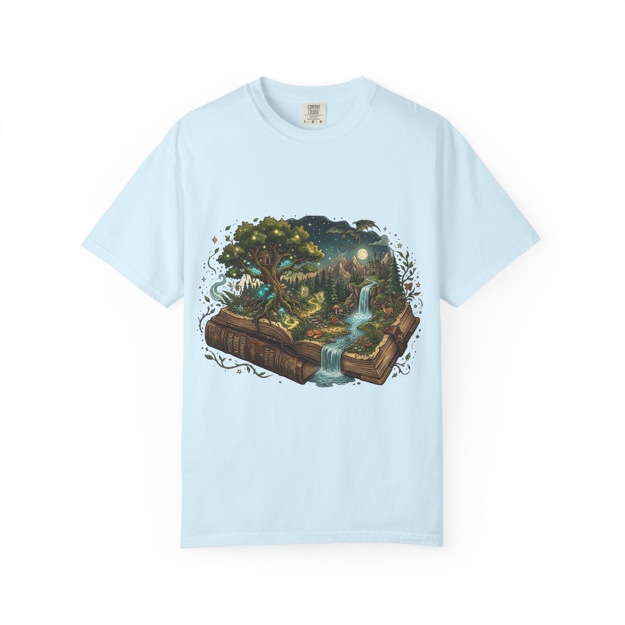 Fantasy book lover tee featuring an enchanted forest, waterfall, and castle emerging from an open book.