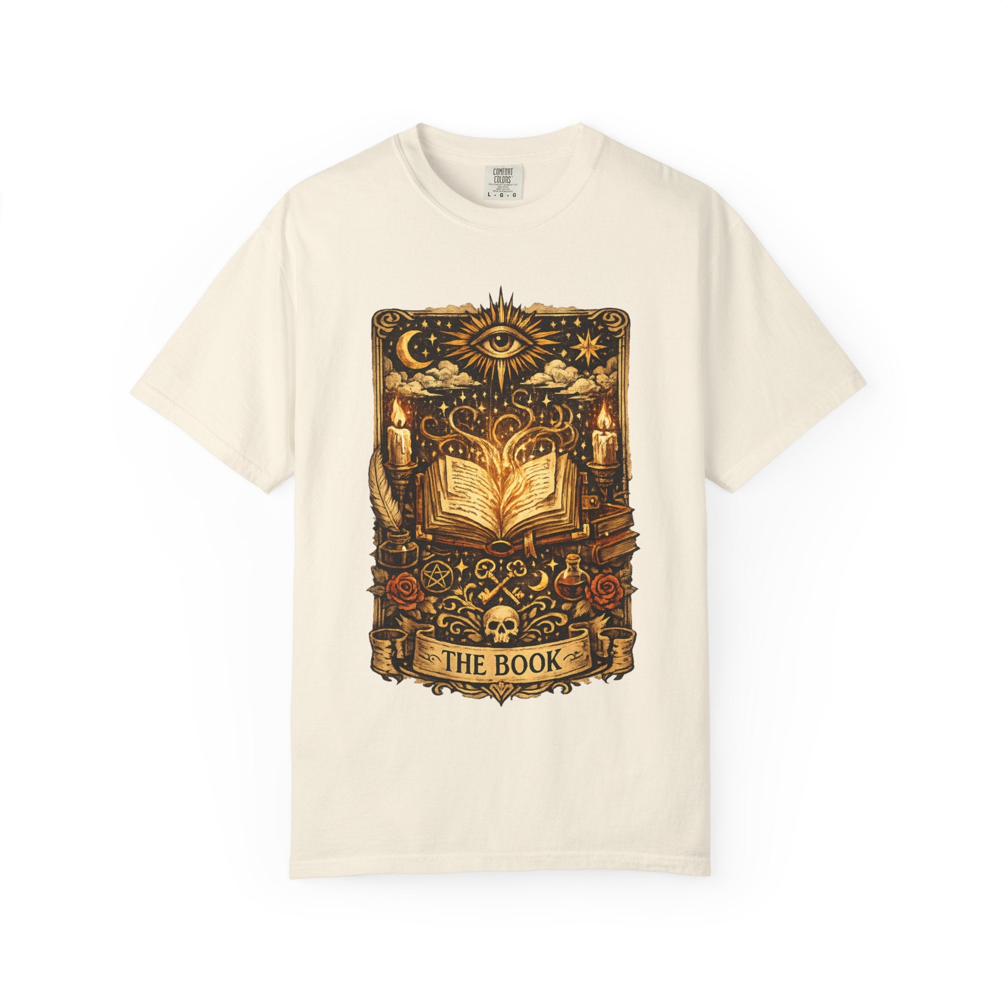 Beige t-shirt with a graphic design of an open book and various symbols on a white background