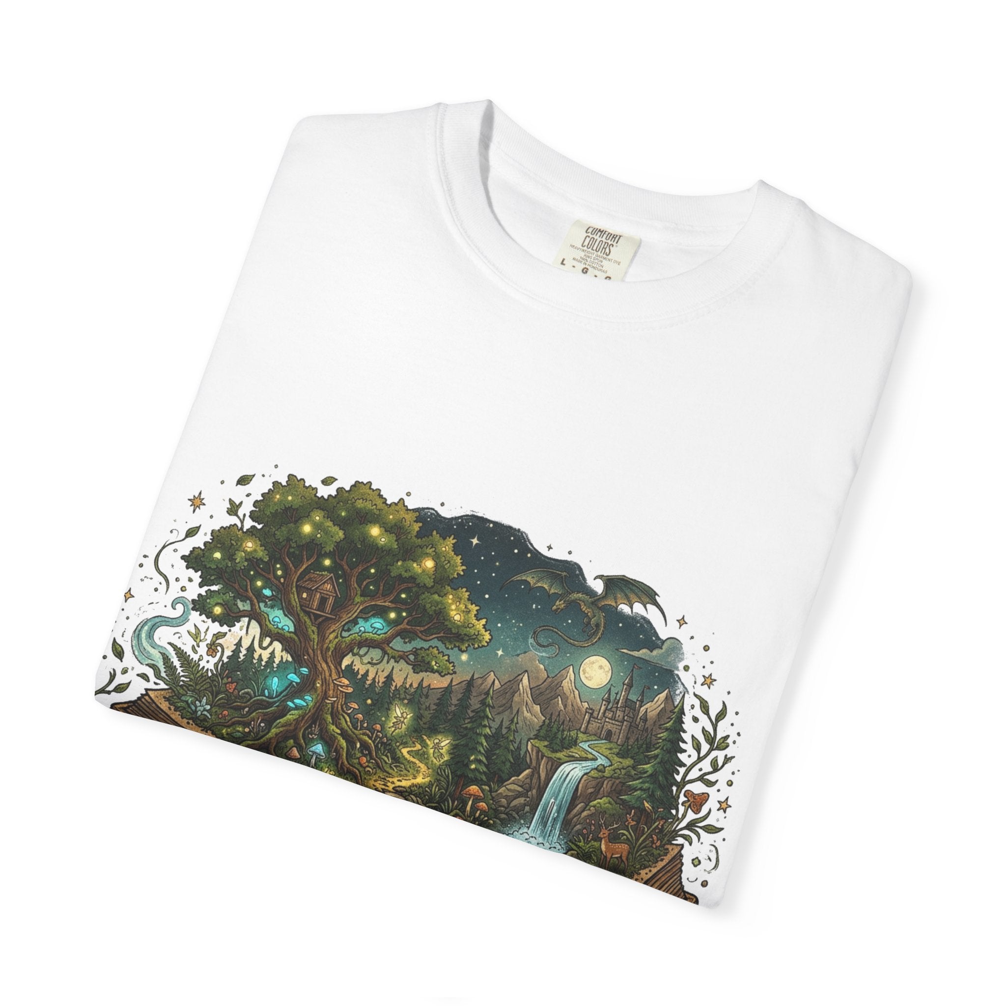 Fantasy book lover tee featuring an enchanted forest, waterfall, and castle emerging from an open book.
