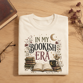 A folded cream-colored t-shirt with a &