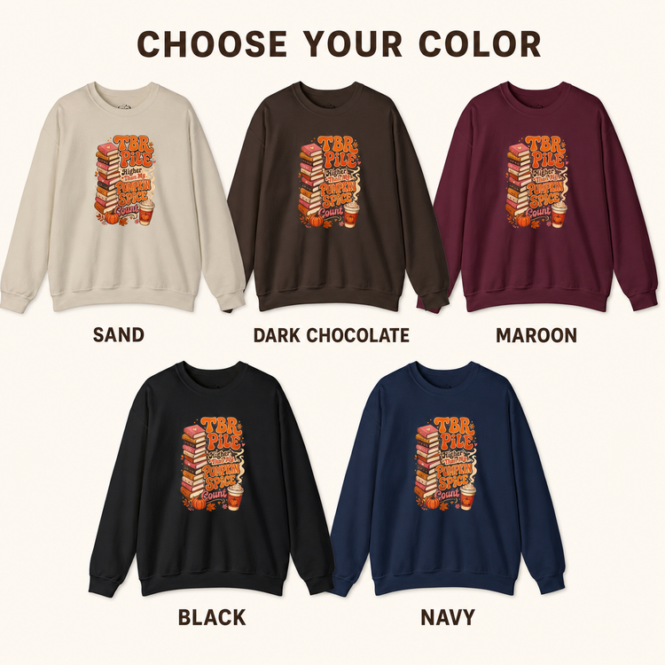 A color selection graphic showing five crewneck sweatshirts labeled SAND, DARK CHOCOLATE, MAROON, BLACK, and NAVY, each with a stack-of-books graphic on the chest under the heading &