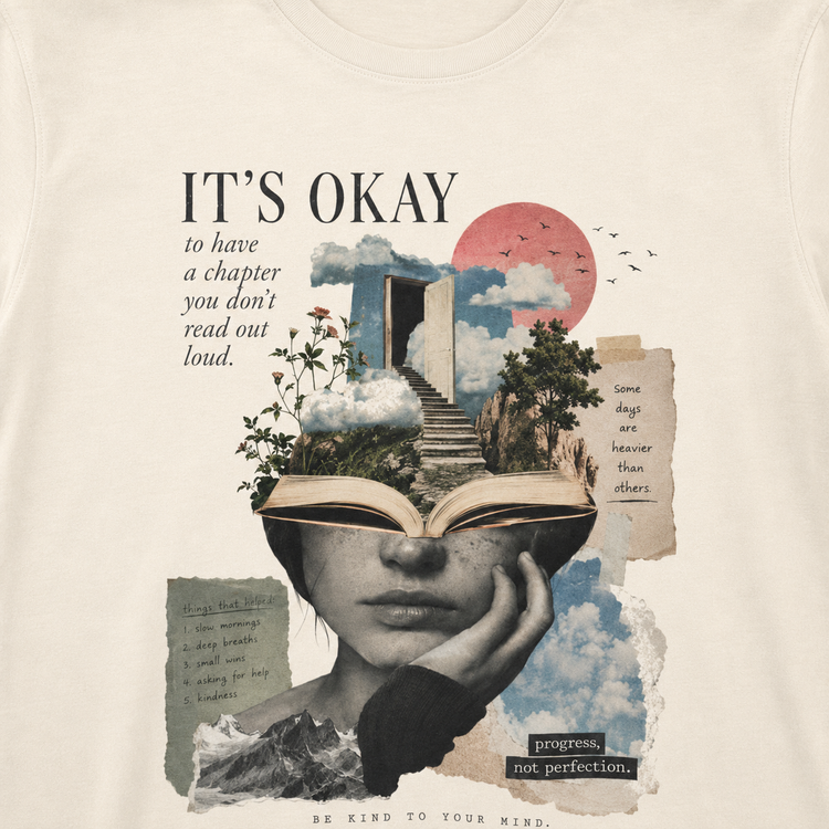 A close-up of a cream-colored t-shirt featuring a detailed graphic print. The design is a surreal collage with the text &