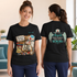 Two women modeling a black graphic t-shirt in a bright indoor setting. The front view shows a colorful medical-themed graphic with a stethoscope, clipboard, pills, and the text &