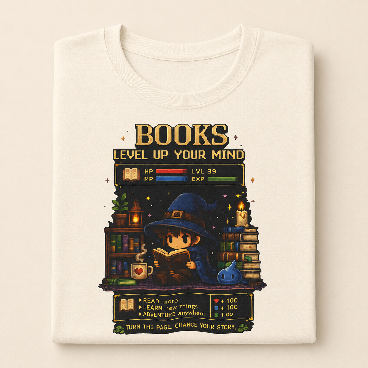 A folded cream-colored t-shirt with a detailed graphic print on the front. The graphic features a whimsical pixel-art illustration of a wizard character reading a book, surrounded by bookshelves, books, a glowing mug, and a blue pumpkin, with the text &