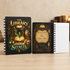 Two spiral-bound notebooks with gothic library-themed designs are displayed on a light wood surface. One notebook shows the front cover with an illustration of an open book, owl, skull, and glowing green potion, with the text &
