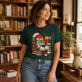A woman wearing a dark green graphic t-shirt with a retro-style book illustration and the text &