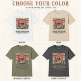 Four Gildan 64000 Softstyle T-shirts shown in a color selection grid: white, sand, military green, and dark heather. Each shirt features a distressed graphic with the text &