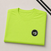 A folded lime green athletic t-shirt with a small circular black and white graphic logo on the left chest, displayed on a light beige background with diagonal black stripes in the top right corner.