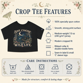 A product infographic for a black crop top t-shirt featuring a graphic print that reads &