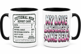 Two white ceramic mugs with black interiors and handles, shown side by side. The left mug features a black-and-white &