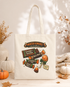 An off-white canvas tote bag with a colorful &