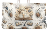 A tote bag featuring a vintage-style illustration print with an open book in the center, surrounded by scattered closed books, quills, ink bottles, keys, and decorative script text on a cream background.