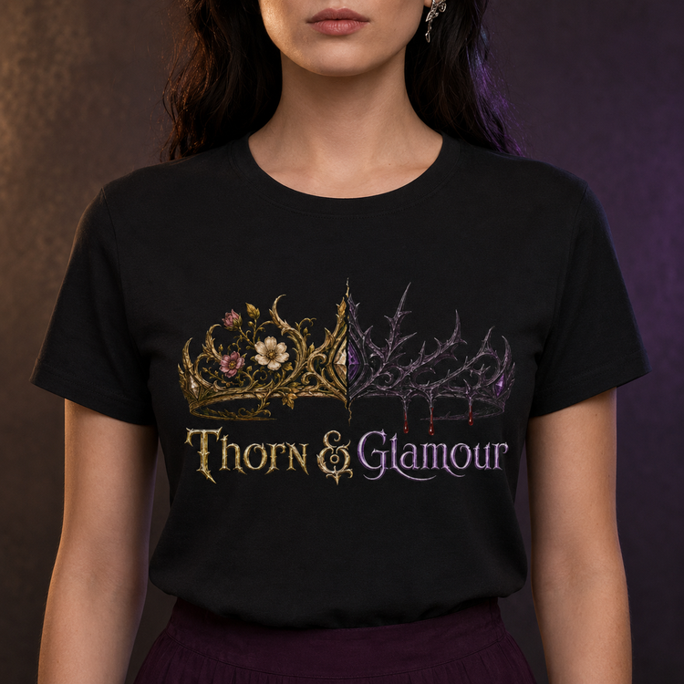A woman wearing a black short-sleeve graphic T-shirt with a decorative crown design and the words &