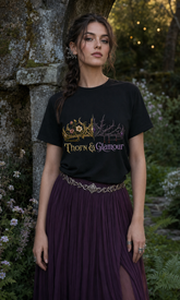A woman wearing a black graphic T-shirt with a gold and purple &