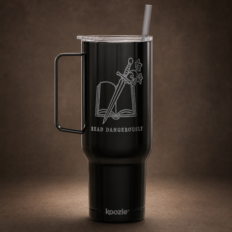 A black insulated travel tumbler with a handle and clear lid, featuring a white laser-engraved design of an open book with a sword and the words &