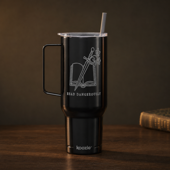 A matte black insulated tumbler with a handle, clear lid, and straw, featuring a white laser-engraved design of an open book and sword with the text &