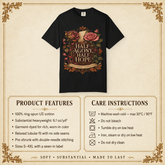 A black graphic T-shirt centered on a beige parchment-style background with decorative corner flourishes. The shirt features a large floral print with roses and a central label reading “HALF AGONY, HALF HOPE” 