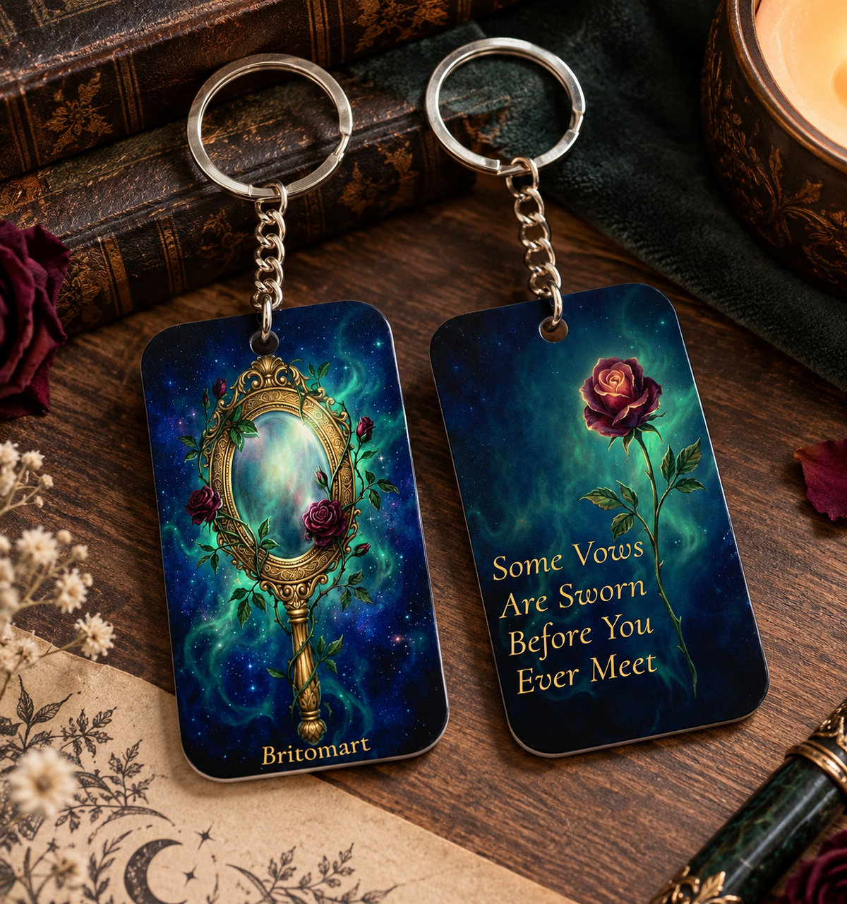 Britomart keychain with a gold mirror on one side and a rose with the text &