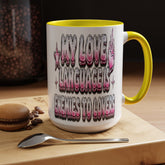 A white ceramic mug with a yellow interior and handle, featuring the text &