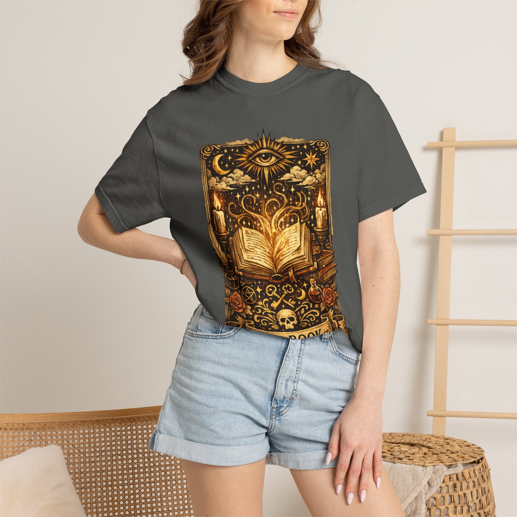 Person wearing a dark gray t-shirt with a gold and black graphic design.