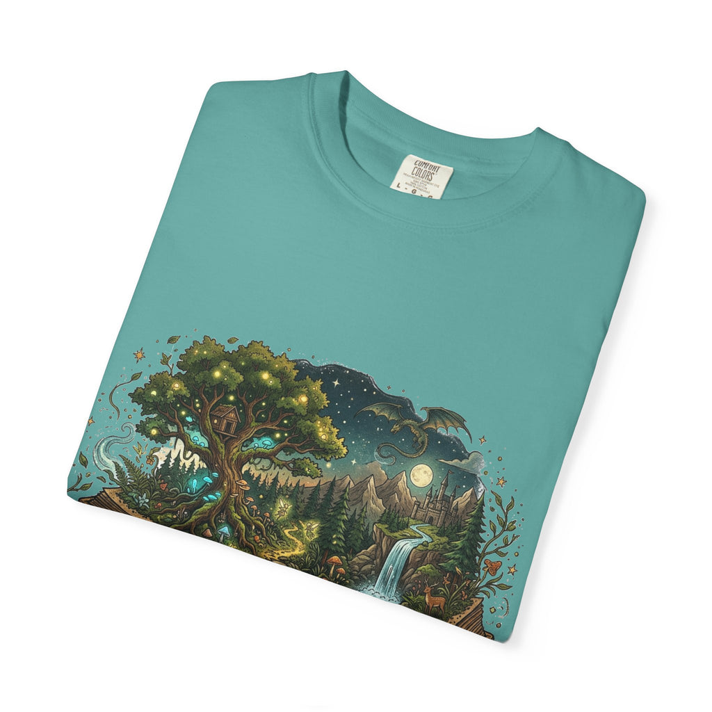 Fantasy book lover tee featuring an enchanted forest, waterfall, and castle emerging from an open book.