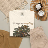 A folded cream-colored t-shirt with the text &