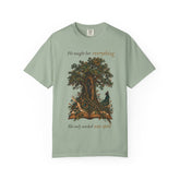 A sage green short-sleeve t-shirt with a graphic of a tree and an open book with a bird, featuring the text &