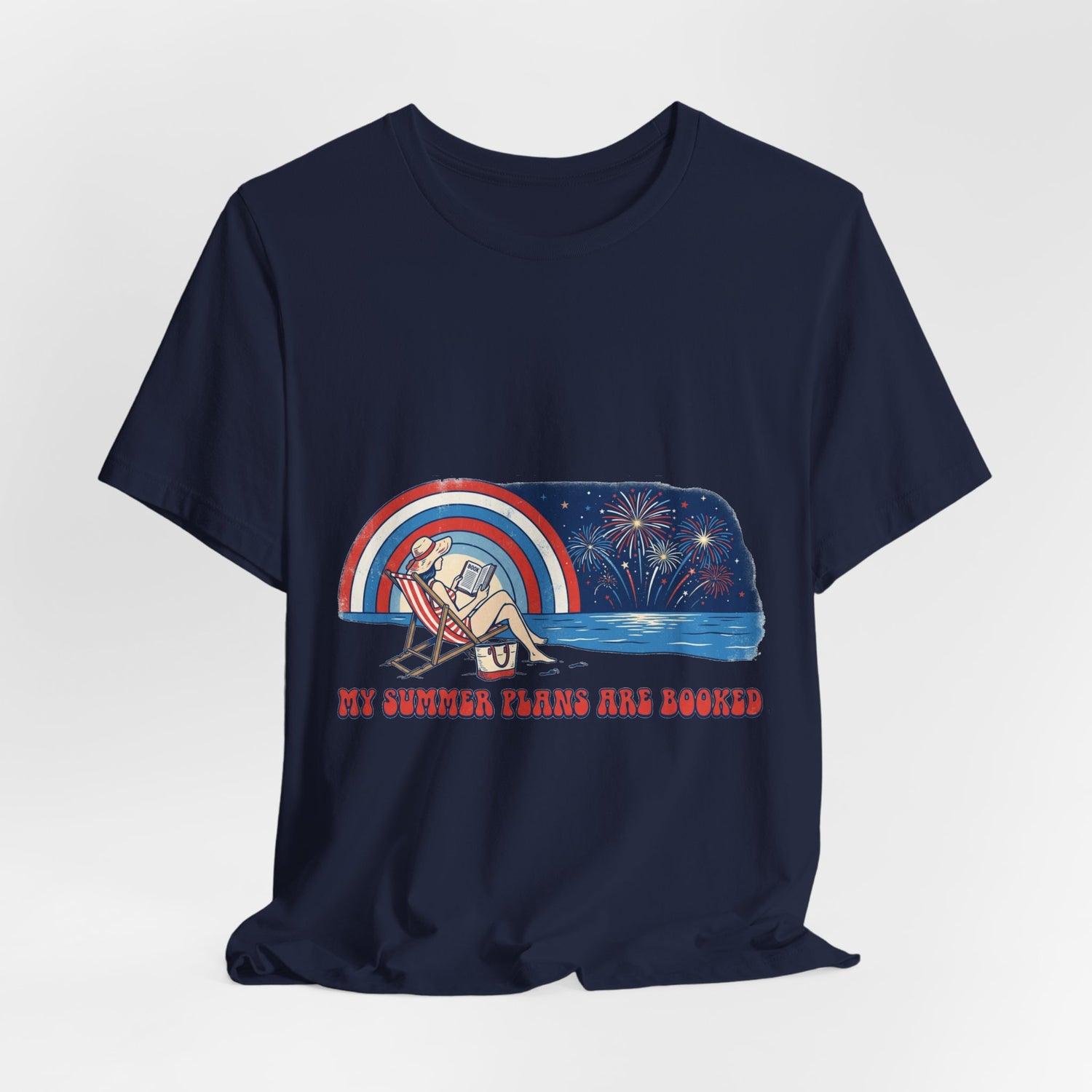 "My Summer Plans Are Booked patriotic t-shirt featuring a woman reading on a beach chair by the water with fireworks, retro rainbow, and red white blue vintage summer design."