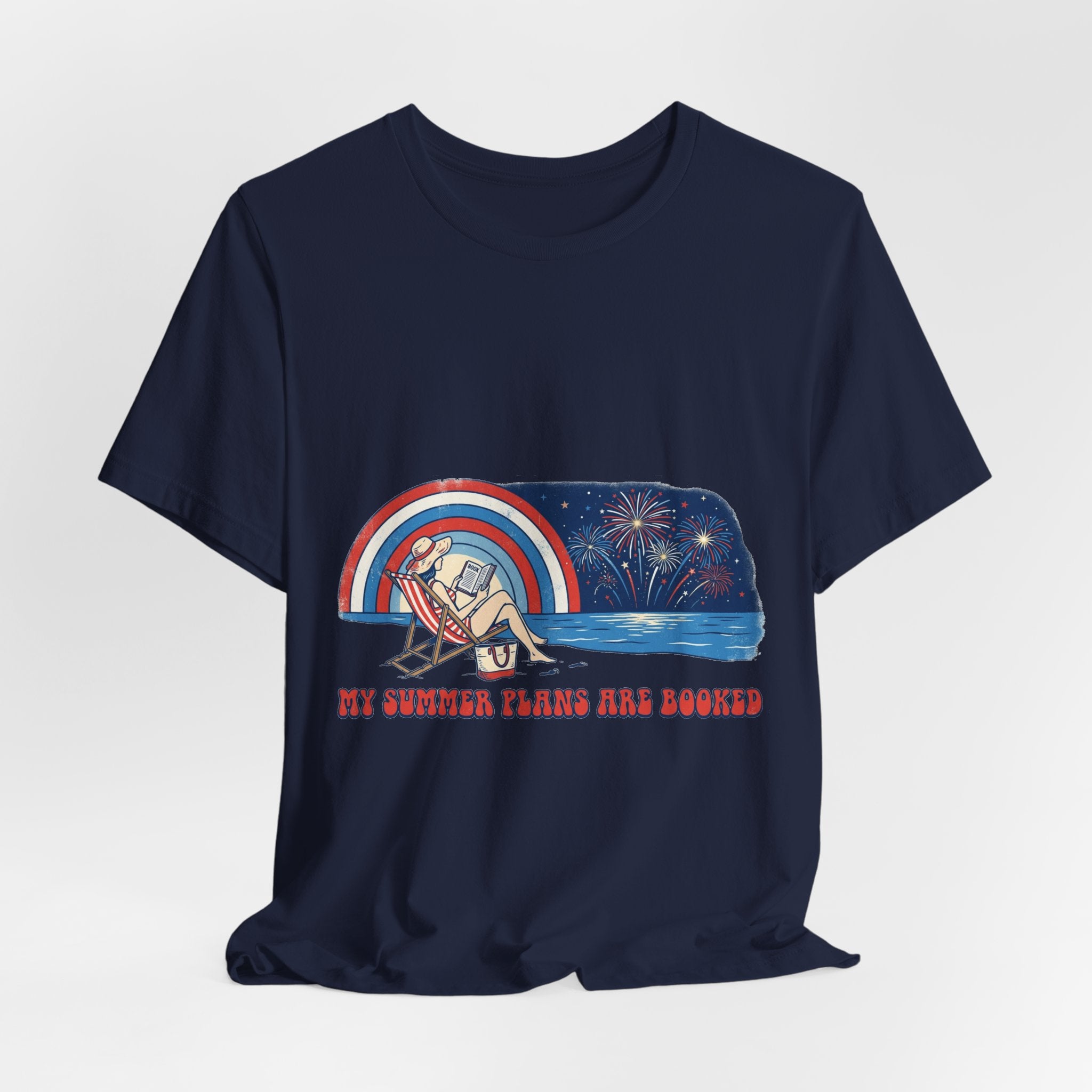 "My Summer Plans Are Booked patriotic t-shirt featuring a woman reading on a beach chair by the water with fireworks, retro rainbow, and red white blue vintage summer design."