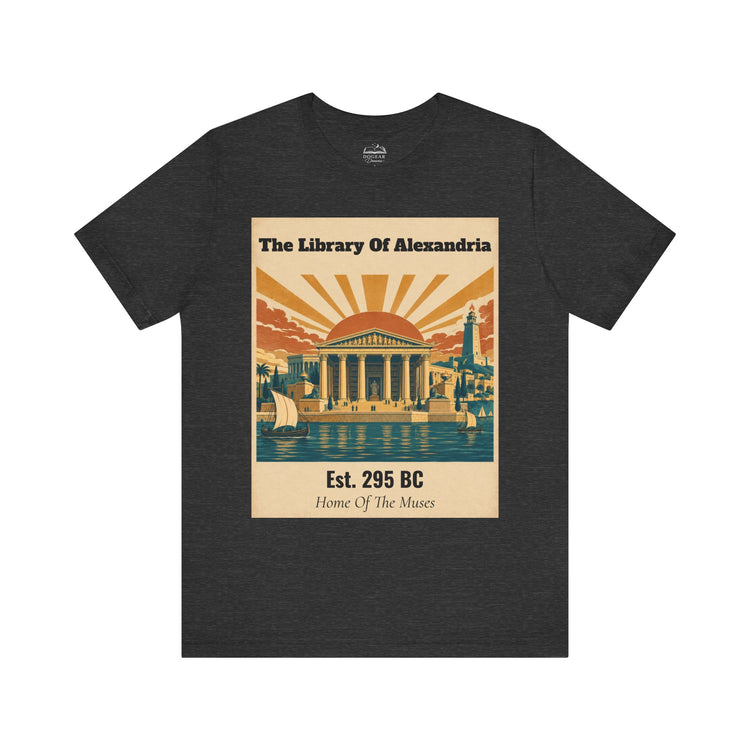 A dark heather gray t-shirt with a vintage-style graphic print on the front. The graphic features a beige background with retro illustrations of the Library of Alexandria, including columns, a sunburst, sailboats, and a lighthouse, with text reading &