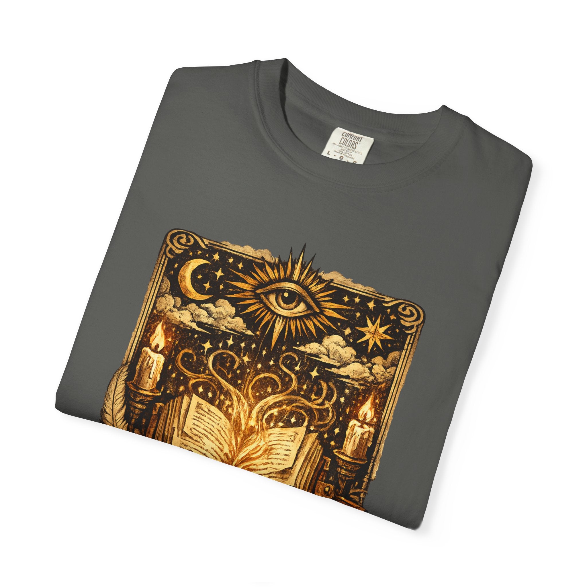 Folded dark gray t-shirt with gold mystical design on a white background