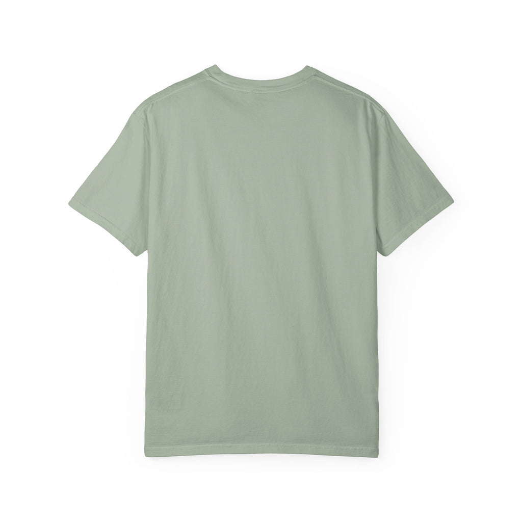 Fantasy book lover tee featuring an enchanted forest, waterfall, and castle emerging from an open book.