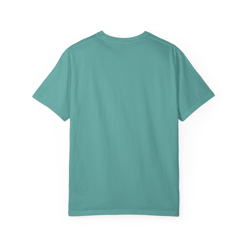 Fantasy book lover tee featuring an enchanted forest, waterfall, and castle emerging from an open book.