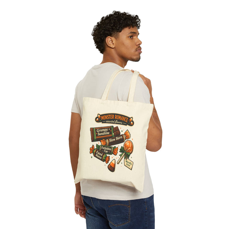 A man wearing a white t-shirt and blue jeans is shown from the back, carrying a cream canvas tote bag over his shoulder. The tote bag features a colorful graphic print with the text &