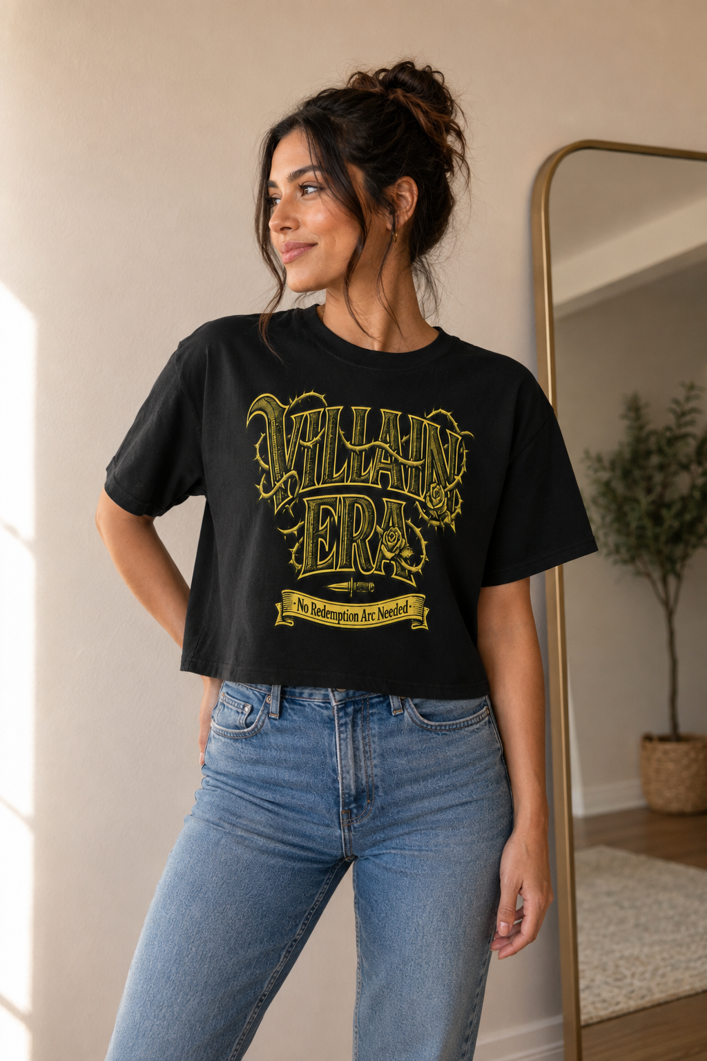 A woman wearing a black graphic t-shirt with a distressed yellow &