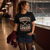 A woman stands in an indoor ice rink corridor wearing a black graphic T-shirt with the phrase &