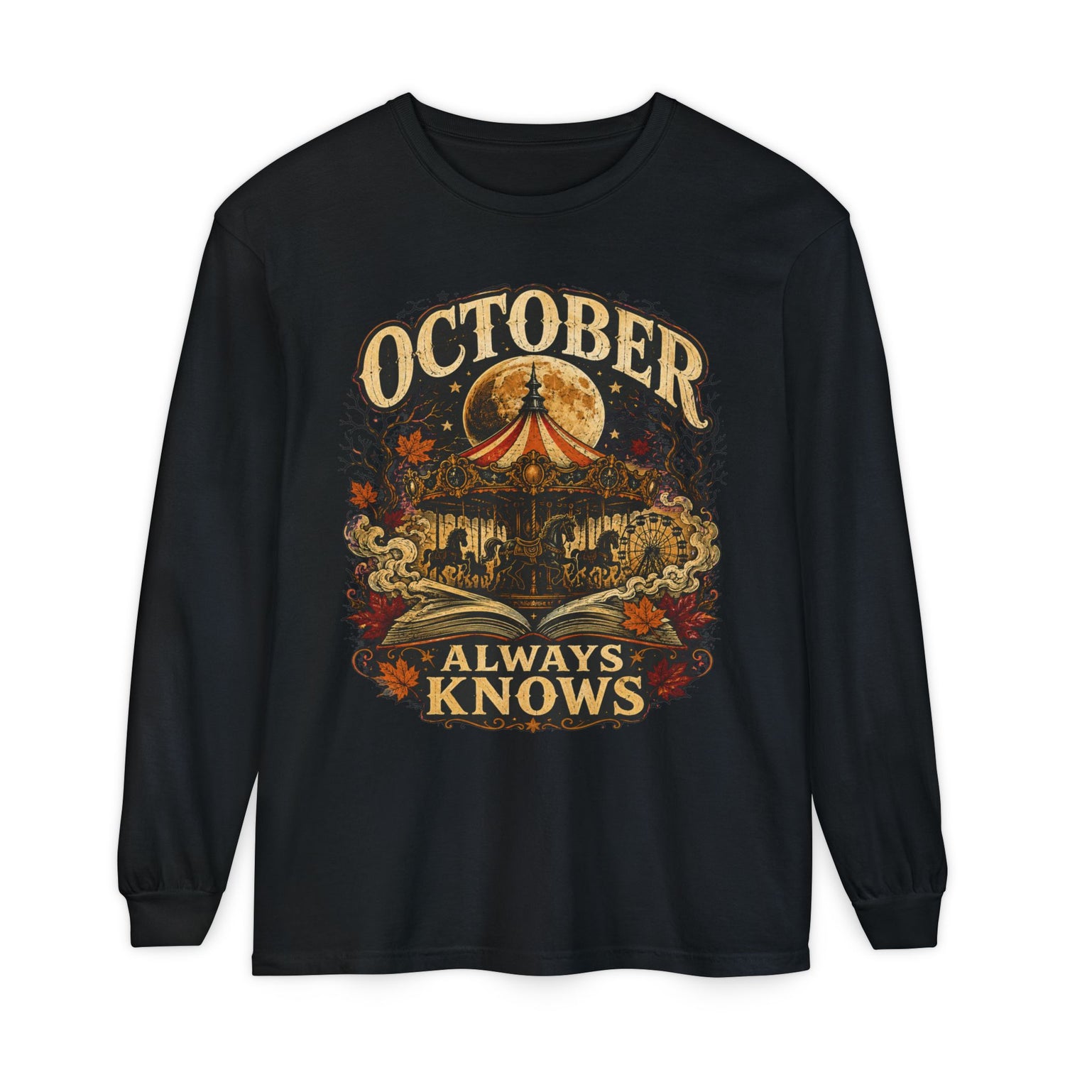 A black long-sleeve t-shirt with a vintage-style Halloween graphic on the front. The graphic features a circus tent under a full moon, a haunted house, autumn leaves, and the text &