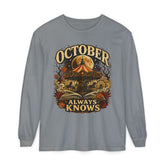 A gray long-sleeve t-shirt with a vintage-style Halloween graphic on the front. The graphic features a haunted house, a glowing full moon, a red-and-yellow circus tent, autumn leaves, and the text &